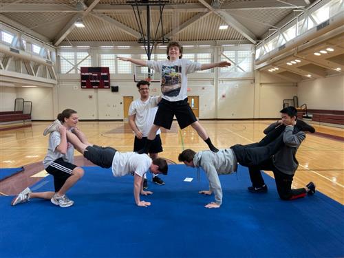Students performing a group balance 